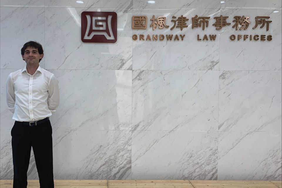 Justin Fuller poses outside of the Grandway Law Firm in Shanghai, China Justin Fuller poses outside of the law firm where he did his international internship