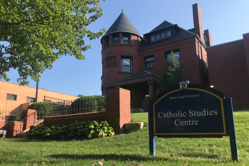 centre Exterior of the 3-story brick building with a sign that reads Catholic Studies Center